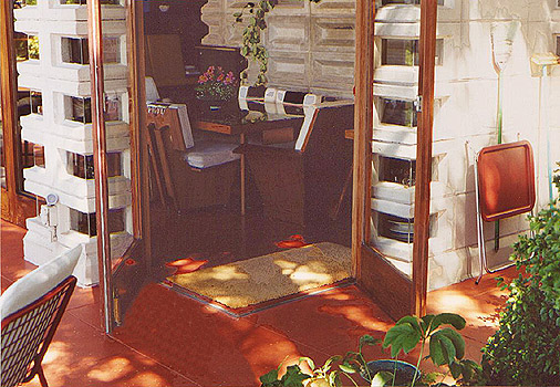 Redwood frame French doors open onto the terrace. Image courtesy of Douglas Steiner. 