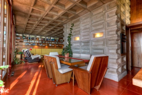 The Tracy House dining room, with Cherokee-red concrete floor tiles. Image courtesy of Redfin. 