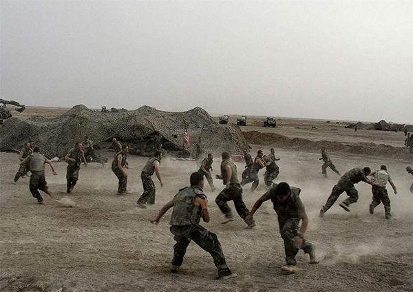 Iraq War, 2003, American soldiers playing football, photograph by Alex Majoli for Magnum Photos. Image courtesy of ARTstor. 